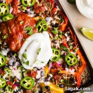 Bell Pepper Nachos with Zesty Cheese and Fresh Toppings 11 Healthy bell pepper nachos topped with a big dollop of greek yogurt and salsa, on a sheet tray
