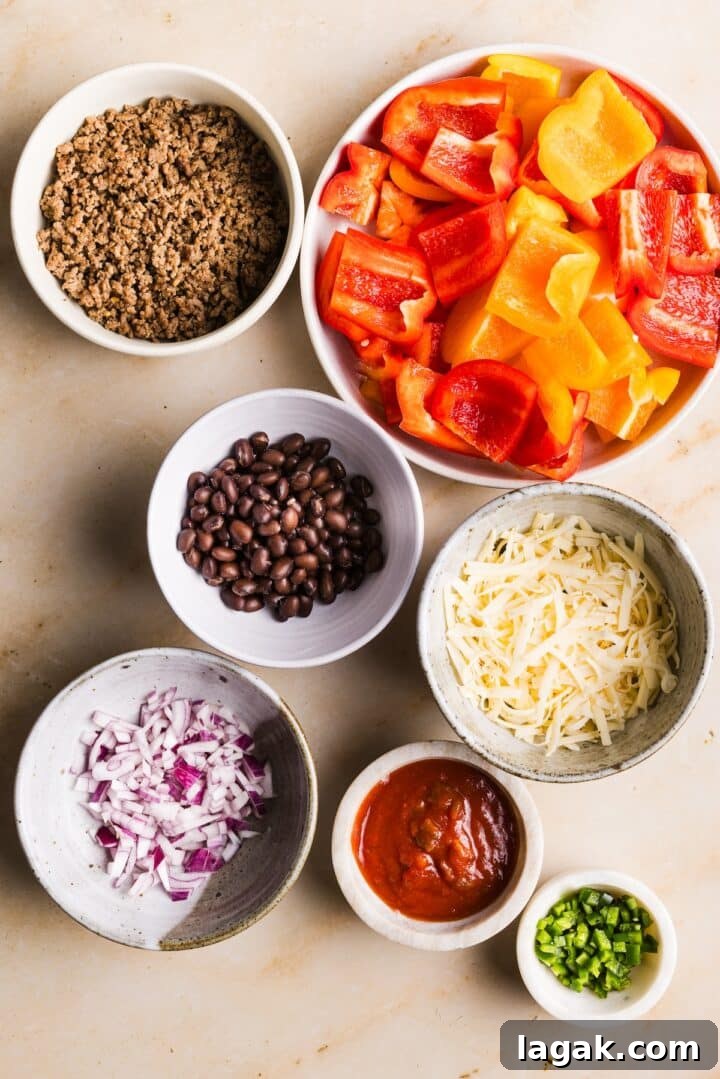 Bell Pepper Nachos with Zesty Cheese and Fresh Toppings 3 Ingredients for easy and healthy bell pepper nachos displayed in small bowls on a beige marble countertop