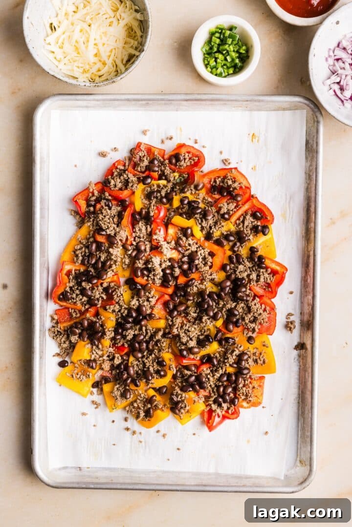 Bell Pepper Nachos with Zesty Cheese and Fresh Toppings 6 Bell peppers on a sheet pan topped with ground beef