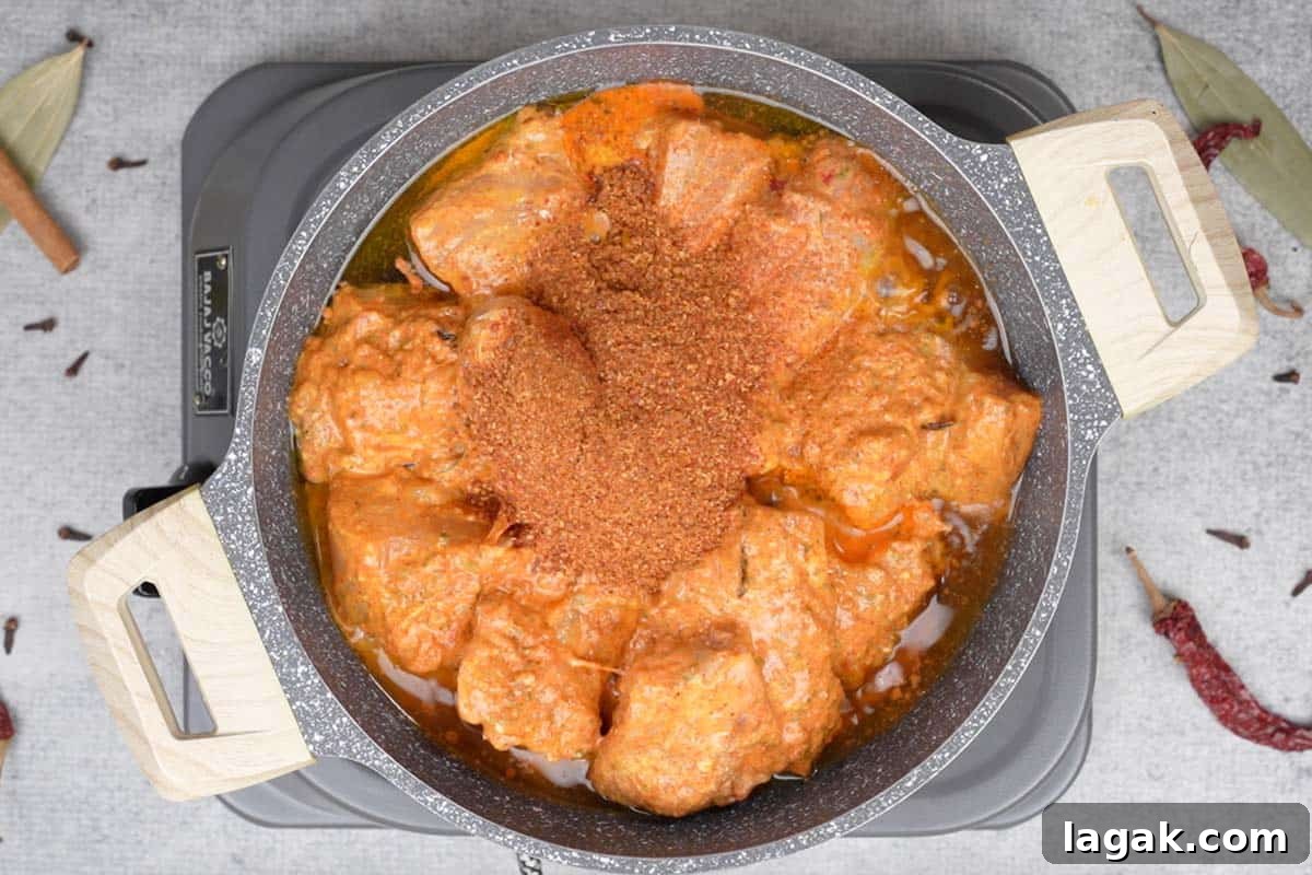 Chicken Angara Recipe: Spicy Grilled Chicken with Smoky Sauce 11 Marinated chicken and spice powder added to the pan.