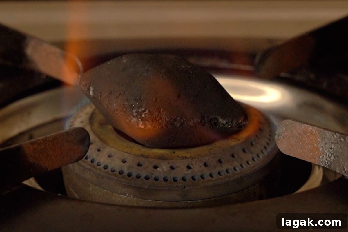 Chicken Angara Recipe: Spicy Grilled Chicken with Smoky Sauce 14 Charcoal heating in a pan.