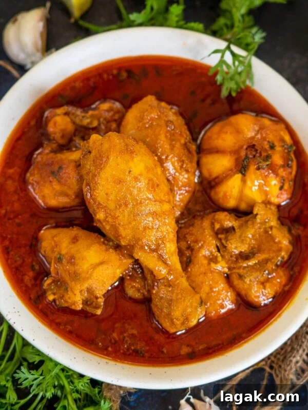 Chicken Angara Recipe: Spicy Grilled Chicken with Smoky Sauce 22 Traditional Bihari Chicken Curry served with garnish.