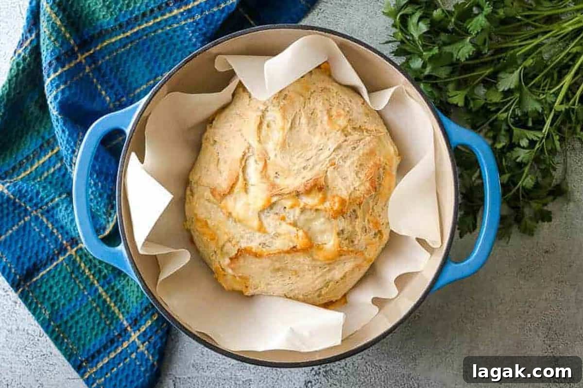 Rosemary Parmesan Loaf Recipe: Crispy Crust, Savory Interior 5 Loaf of baked bread in a Dutch oven.