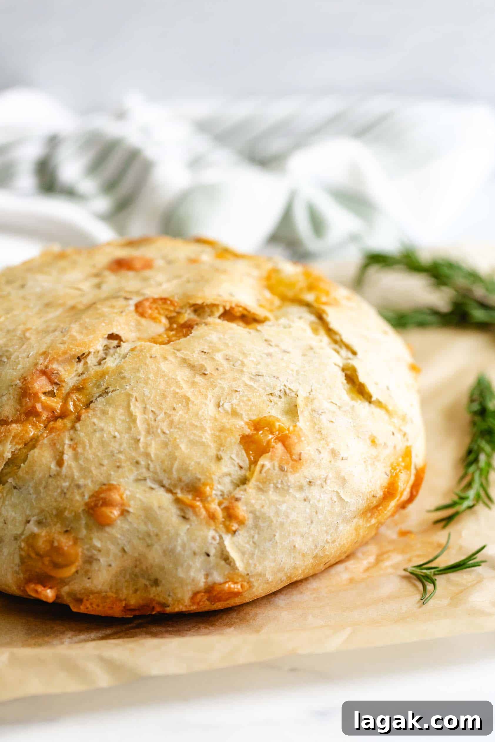 Rosemary Parmesan Loaf Recipe: Crispy Crust, Savory Interior 7 Loaf of parmesan rosemary bread on parchment paper.