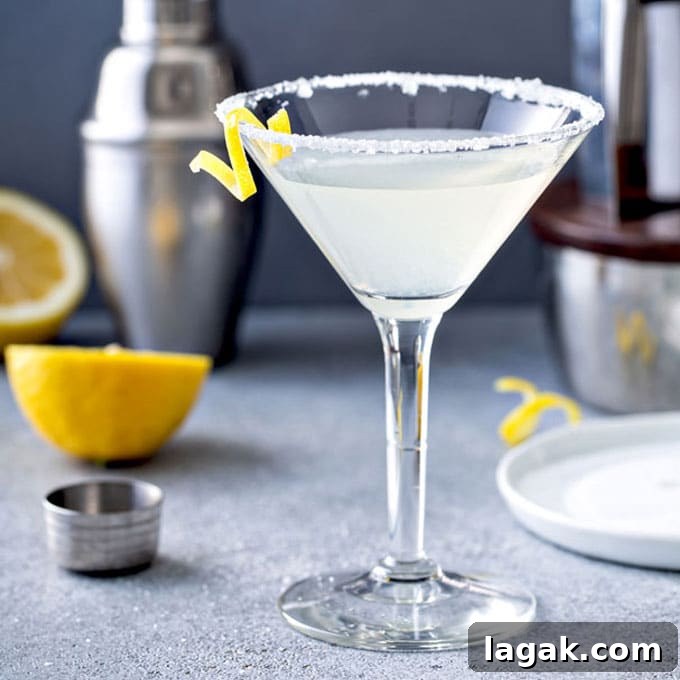 14 Romantic Valentine's Day Recipes to Make at Home 14 A glass of lemon drop martini cocktail with sugar on the martini glass and a lemon twist