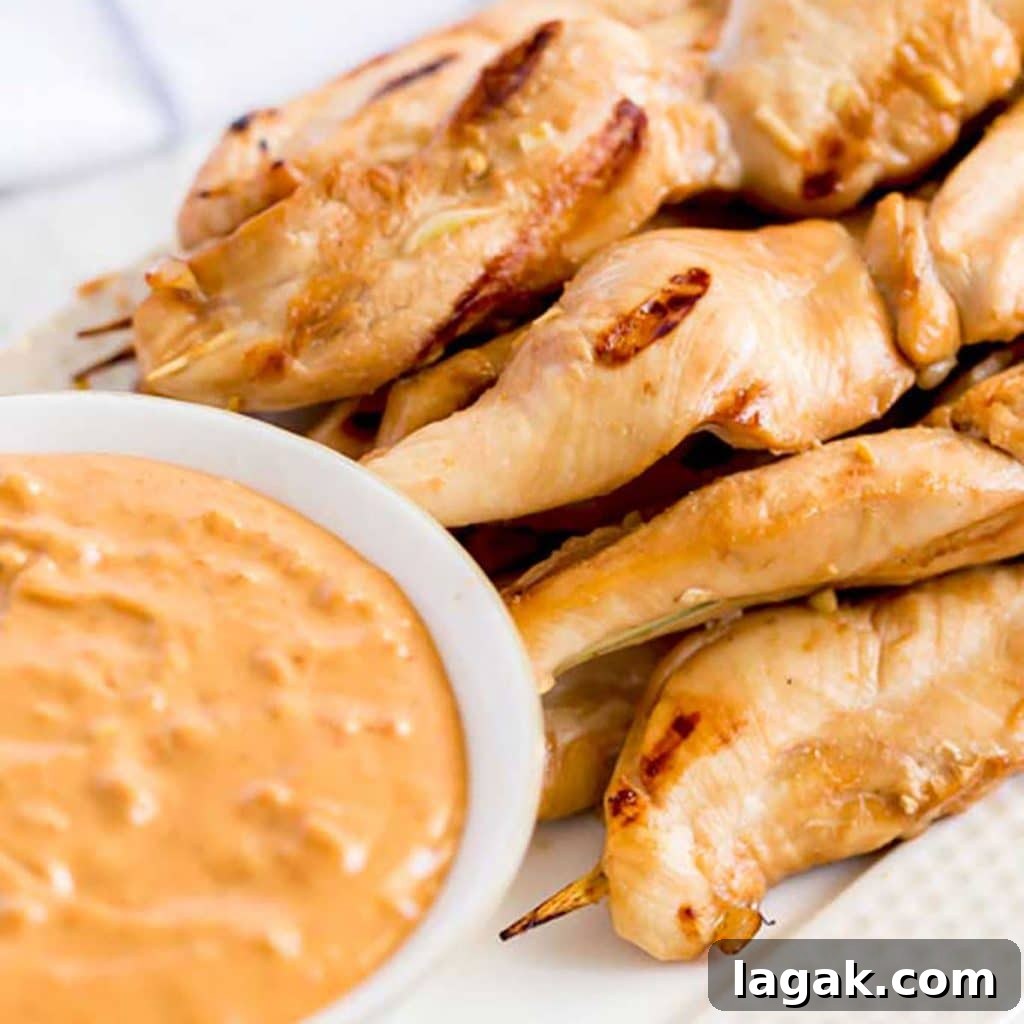 14 Romantic Valentine's Day Recipes to Make at Home 5 Grilled Chicken Skewers next to a bowl of dipping sauce