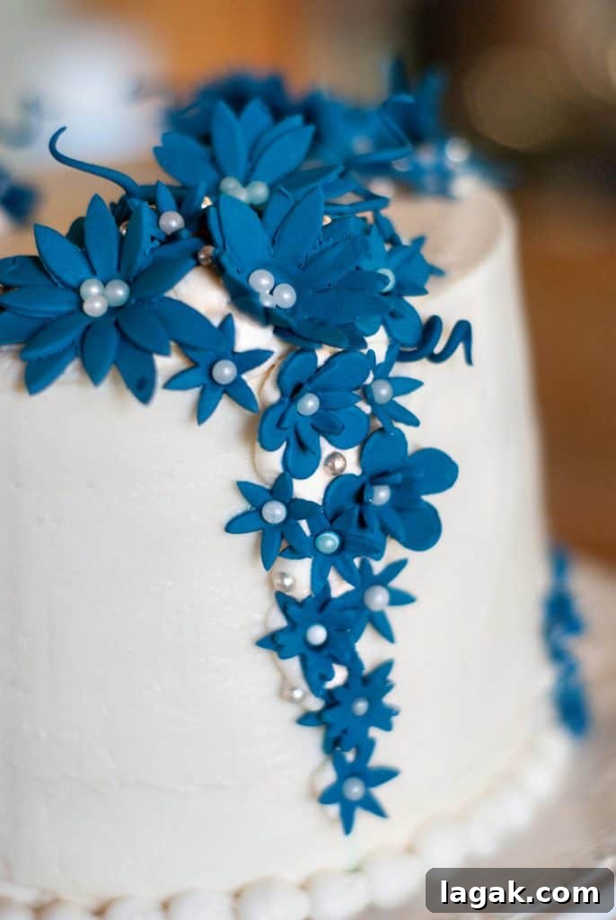Classic Red Velvet Cupcakes with Cream Cheese Frosting 4 Easy cake with white frosting and decorative blue flowers.