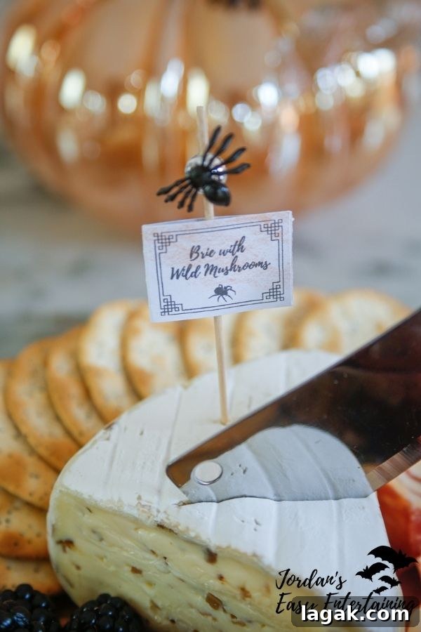 a wedge of Brie cheese with a free printable Halloween cheese label