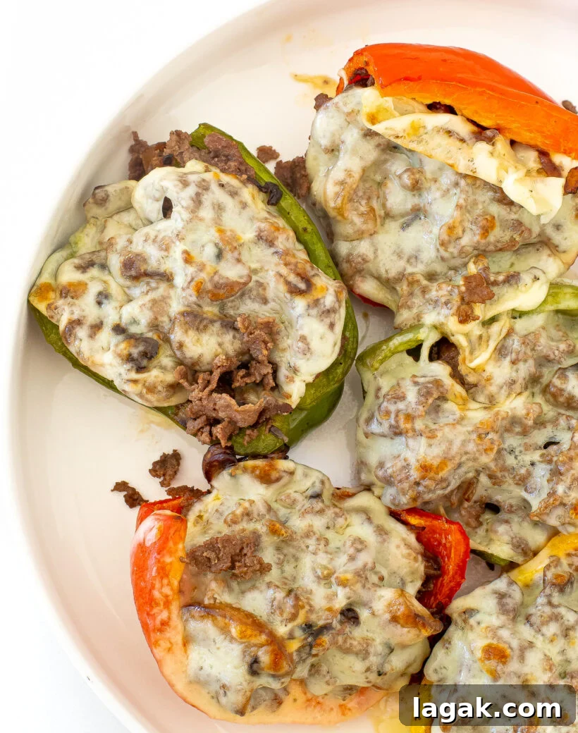 Philly Cheesesteak Stuffed Bell Peppers: Savory Low-Carb Dinner 13 Stuffed Bell Peppers on a white plate.