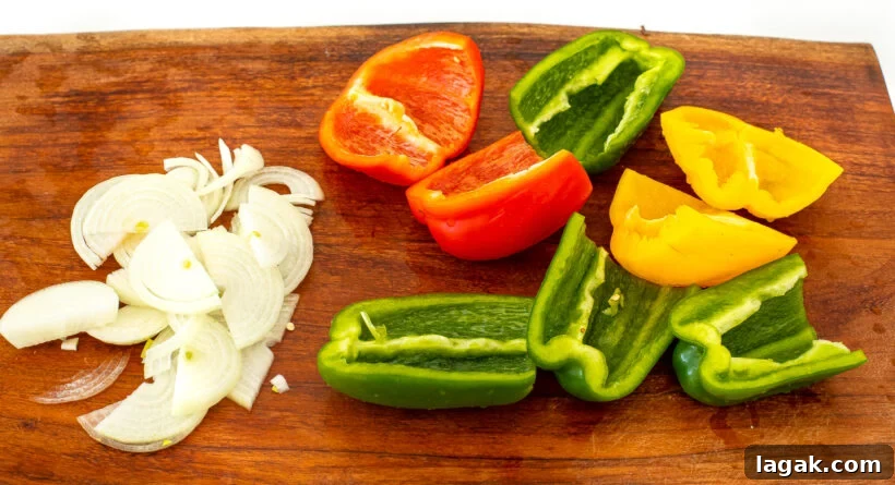 Philly Cheesesteak Stuffed Bell Peppers: Savory Low-Carb Dinner 4 Onions and peppers on a cutting board.
