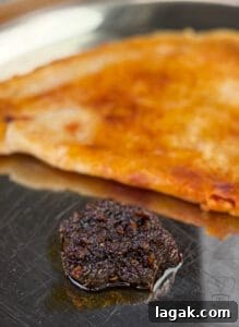 Tangy South Indian Ginger Pickle (Inji Thokku) Recipe 3 Traditional ginger pickle served with crispy flatbread on a metal plate.