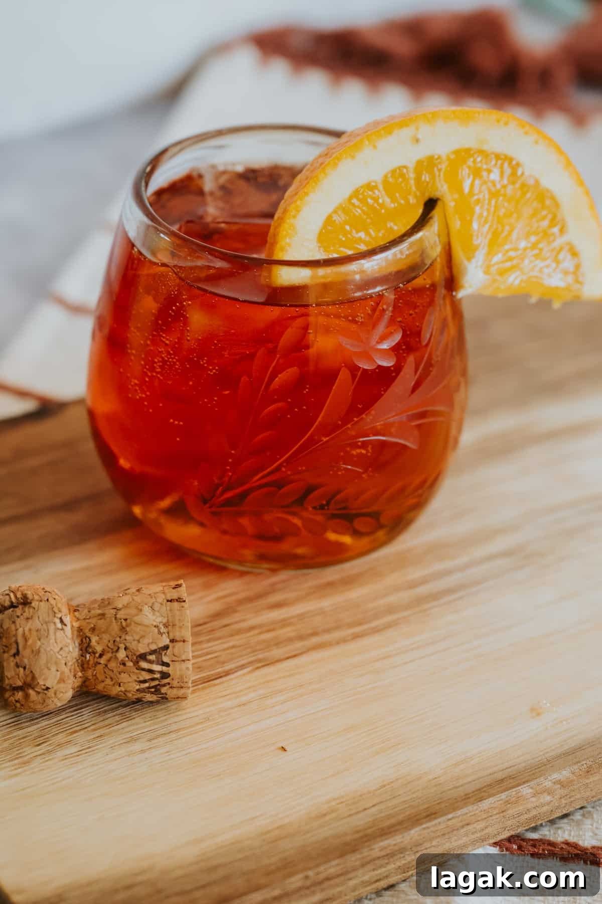 Classic Aperol Spritz Recipe: How to Make the Perfect Cocktail 9 etched stemless wineglass filled with an Aperol spritz garnished with an orange slice.