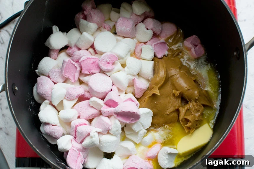 Ingredients for making peanut butter Cheerio bars in a pan from above