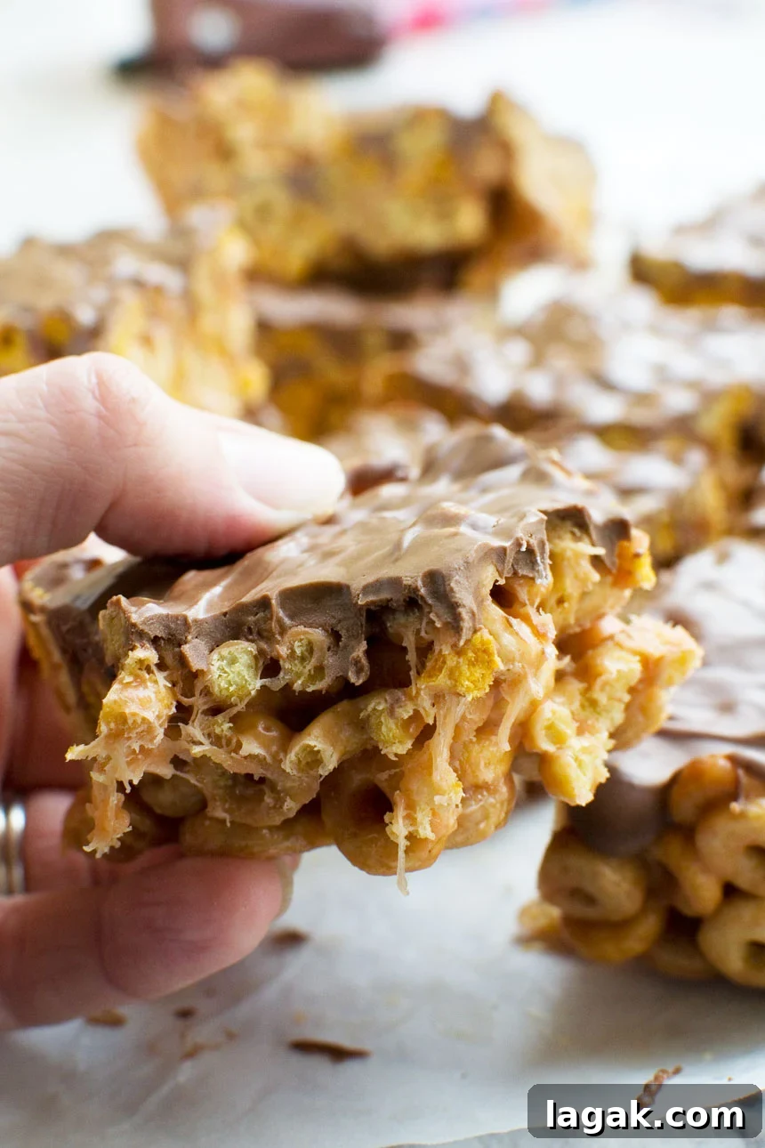 Closeup of someone eating a peanut butter cheerio bar 