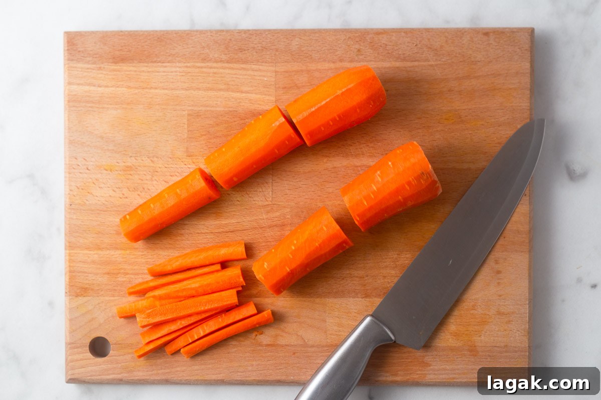 Crispy Air Fryer Carrot Fries Recipe for a Crunchy Snack 4 cutting carrots into fries.