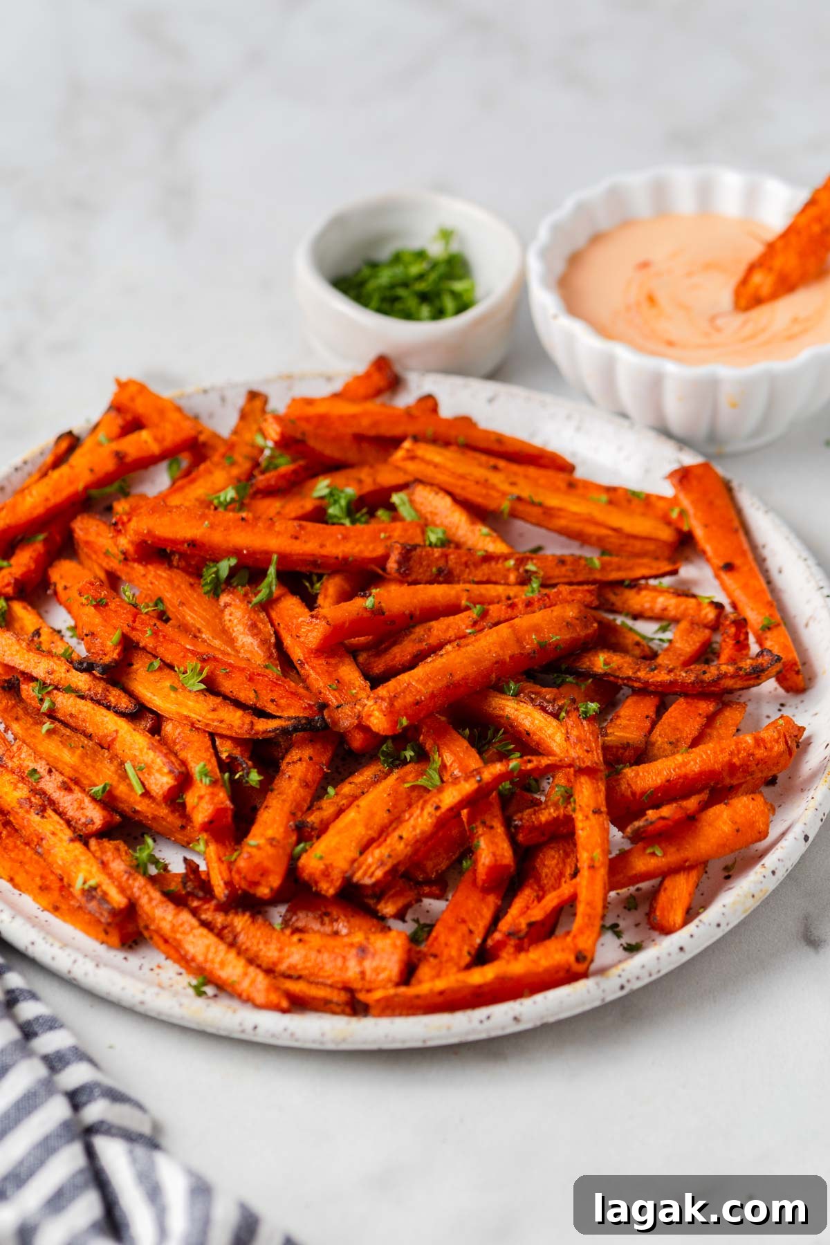 Crispy Air Fryer Carrot Fries Recipe for a Crunchy Snack 9 air fried carrot fries with dip and parsley.