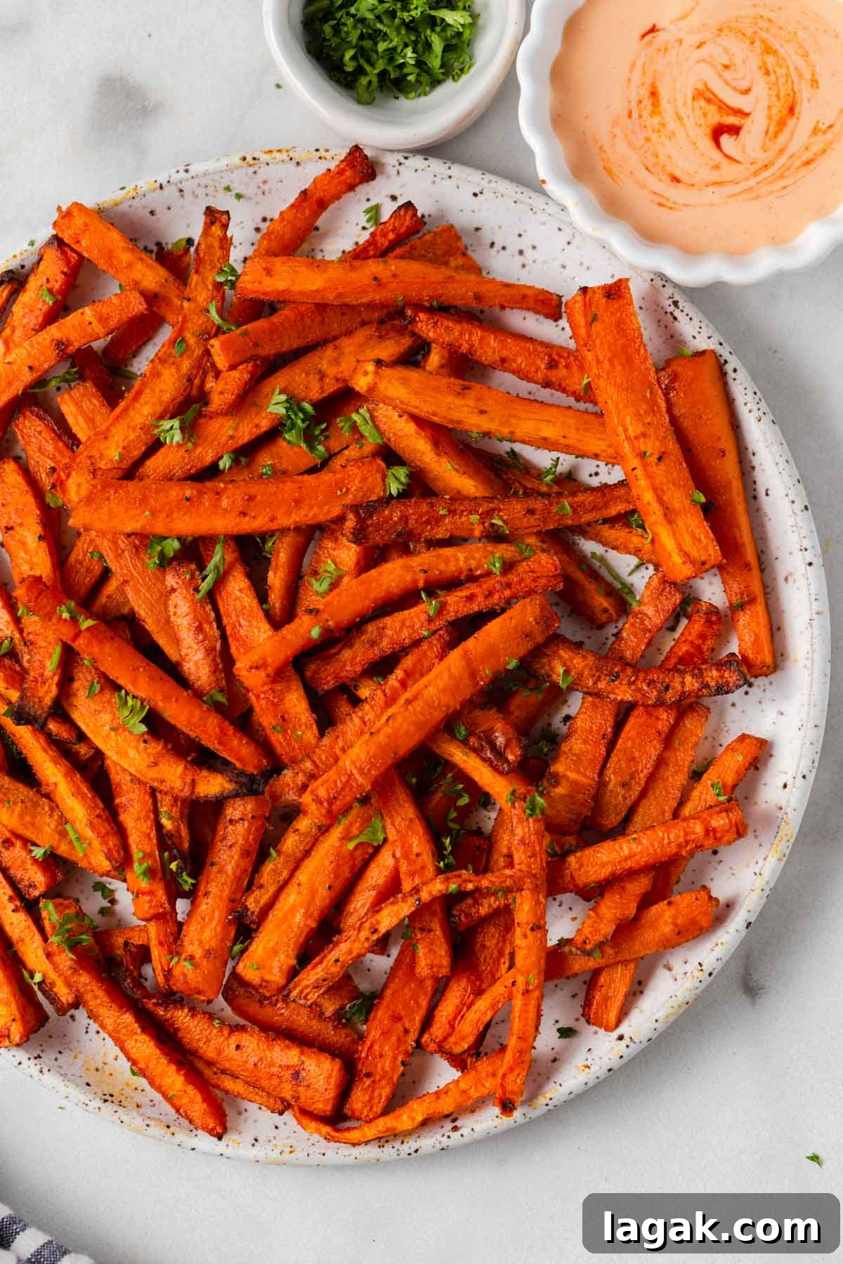 Crispy Air Fryer Carrot Fries Recipe for a Crunchy Snack 10 carrot fries with a dip on a plate.