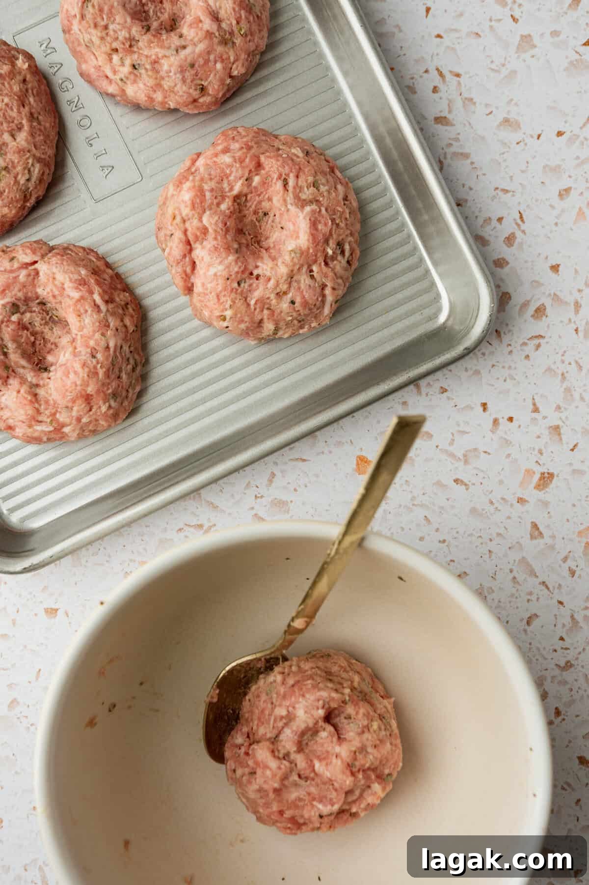 Juicy Ground Pork Burger Recipe for Flavorful Weeknight Meals 5 Uncooked burger patties on a baking sheet.
