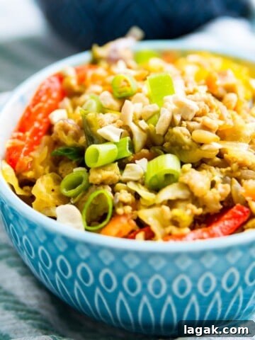 A bowl of healthy egg roll in a bowl garnished with green onion.