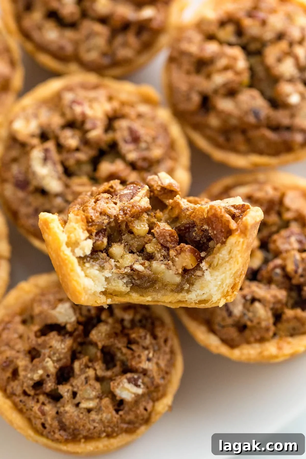 Grandma Rose’s Pecan Tassies Recipe for Perfect Bite-Sized Pies 8 A close up image of a pecan tart cut open revealing the inside of it.