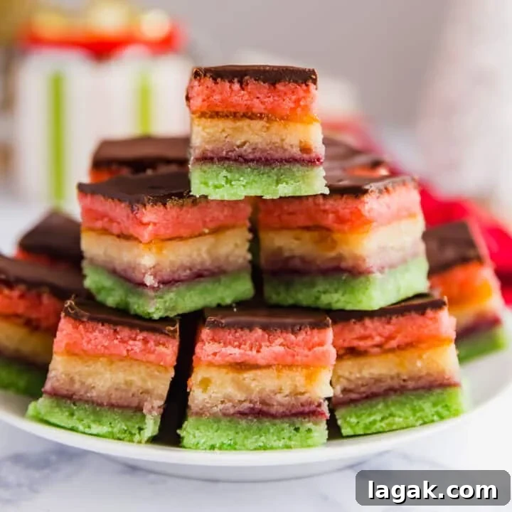 A plate of Neapolitan cookies stacked into a pyramid shape.