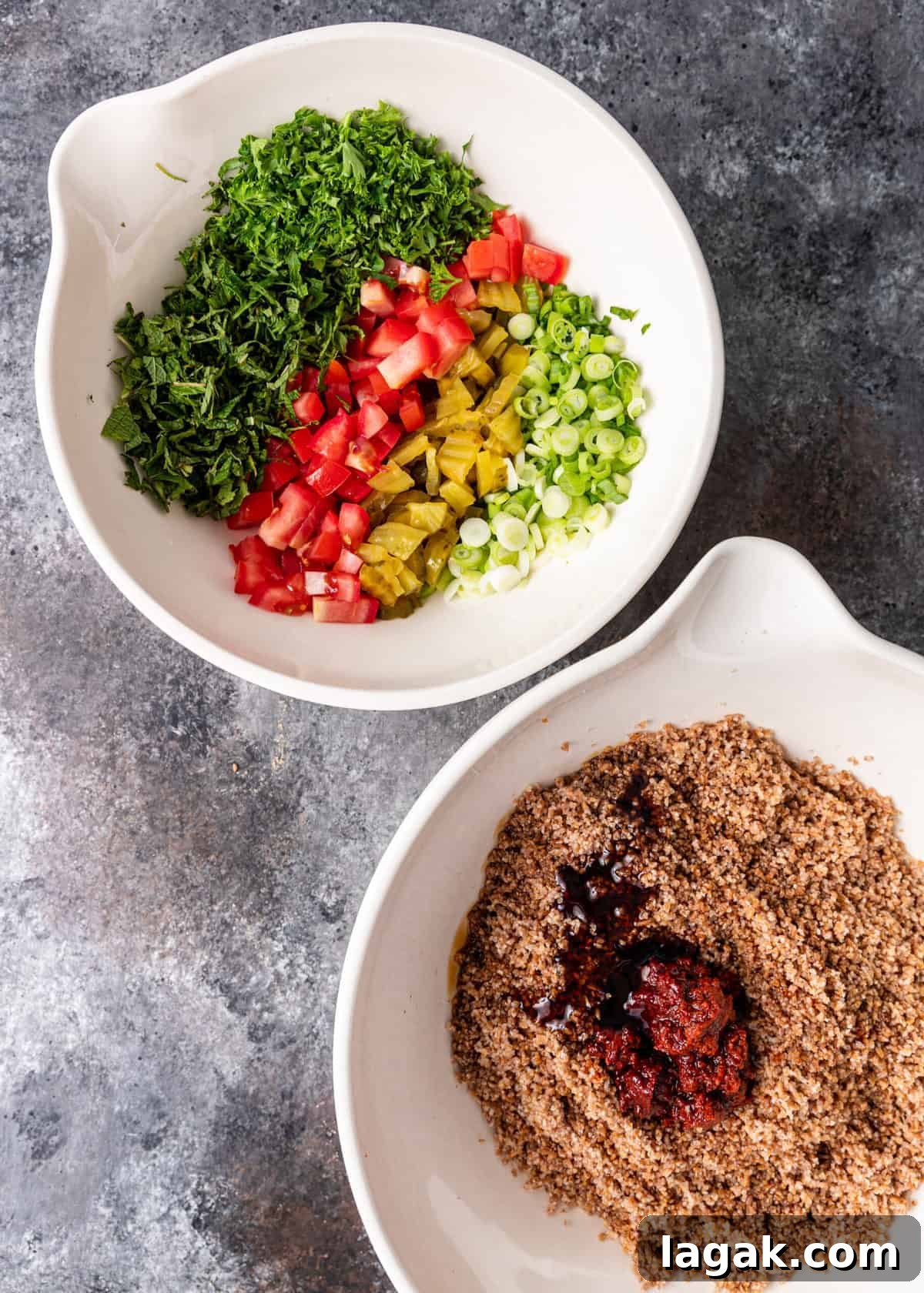 overhead: two white mixing bowls side by side. One with bulgur and one with chopped salad vegetables