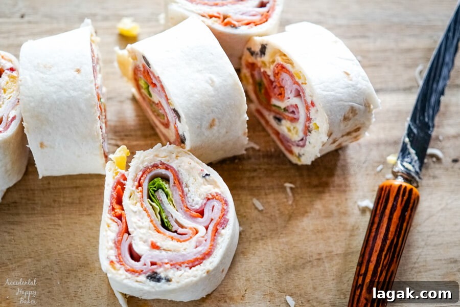 Italian Pinwheel Appetizers: Savory Tortilla Roll-Ups Recipe 6 A cutting board with a freshly sliced pinwheel.