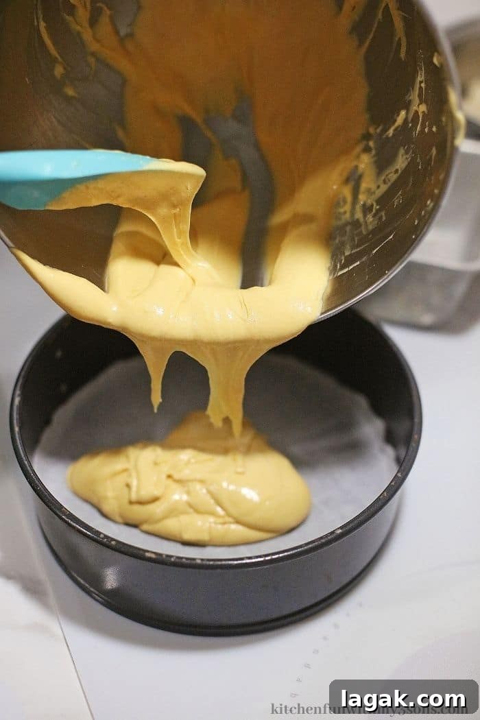 No-Bake Orange Cream Cheesecake Recipe for Zesty Summer Desserts 4 Adding the cheesecake batter into the pan.