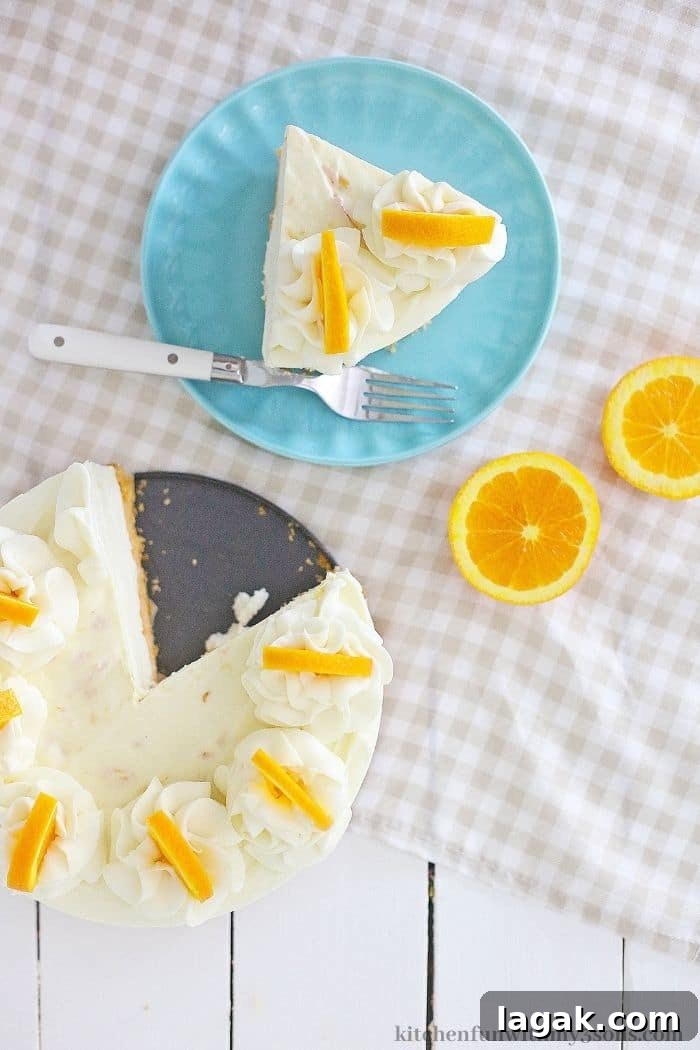 No-Bake Orange Cream Cheesecake Recipe for Zesty Summer Desserts 7 A slice of the cheesecake next to the rest of the cheesecake.
