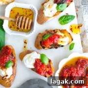 Tomato Confit & Burrata Crostini with a spicy sweet drizzle of chili honey