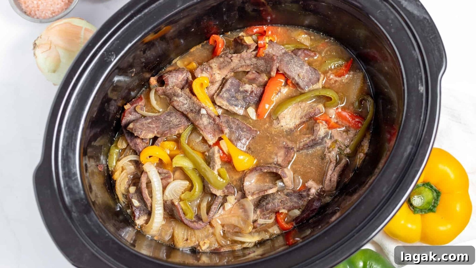 21 Slow Cooker Dinners for Stress-Free Weeknight Meals 21 A crock pot filled with beef and peppers.