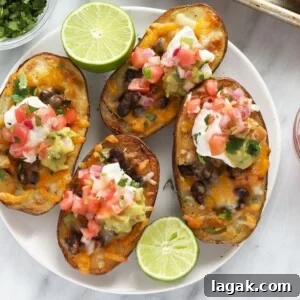 Mexican potato skins with guacamole and sour cream on a plate.