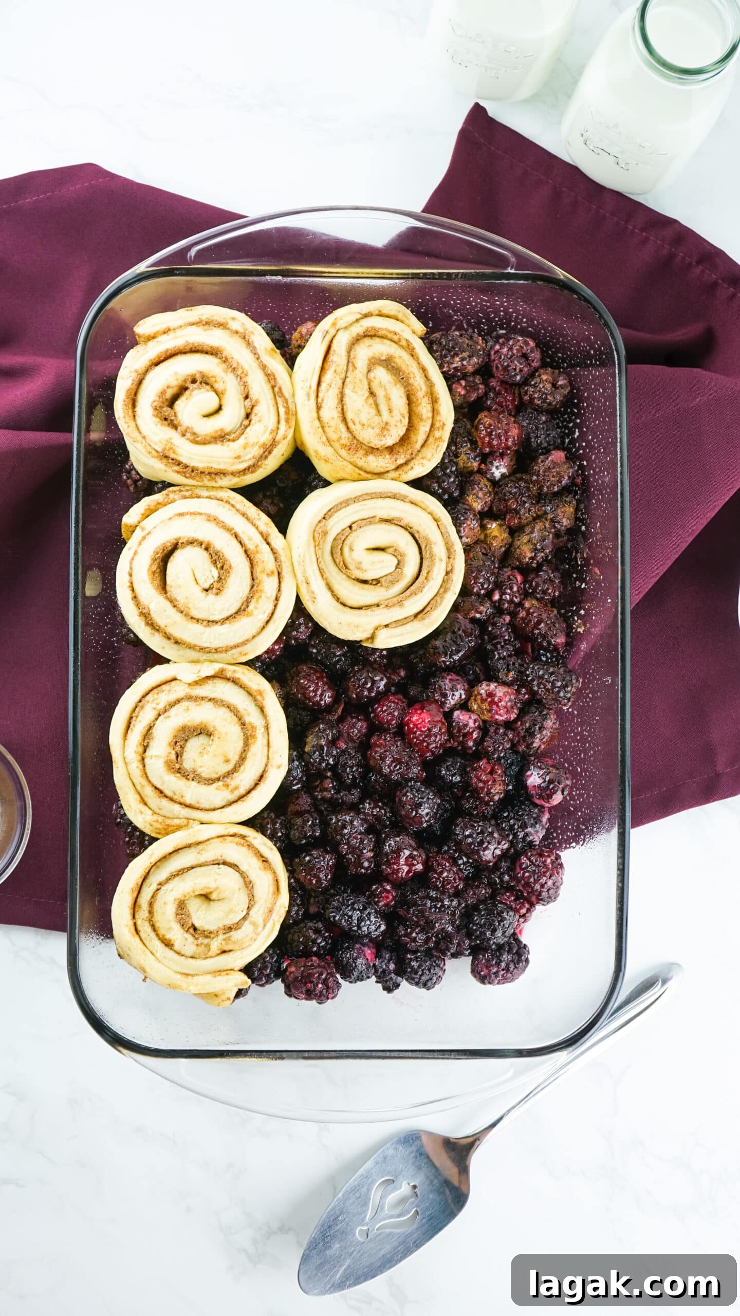 Classic Blackberry Cobbler Recipe for Perfect Summer Desserts 8 raw cinnamon rolls on top of blackberries in a baking dish