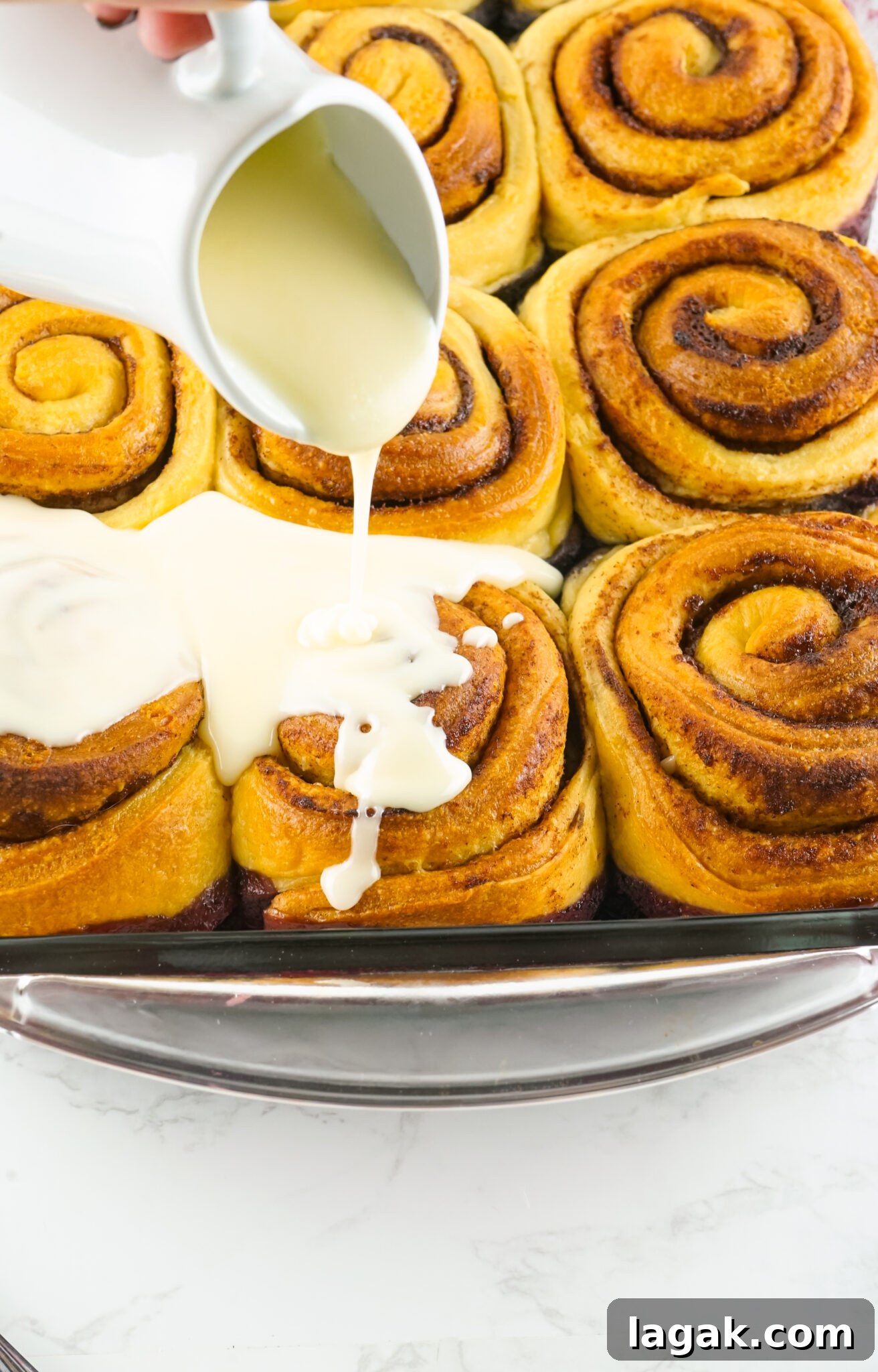Classic Blackberry Cobbler Recipe for Perfect Summer Desserts 10 cinnamon roll frosting being poured on top of the cinnamon roll cobbler