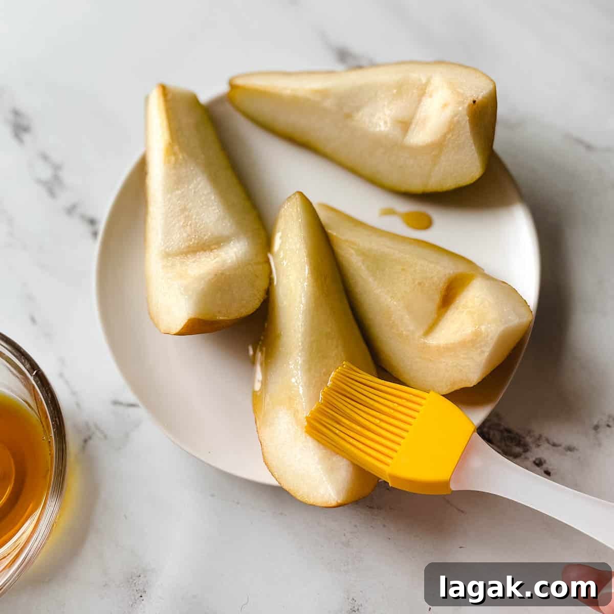 Air Fryer Cinnamon Pears Recipe 7 Pears are brushed with maple syrup.