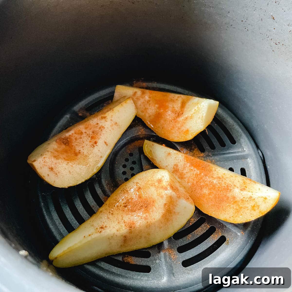 Air Fryer Cinnamon Pears Recipe 8 Pear slices are added to the Air Fryer basket and dusted with cinnamon and cayenne.
