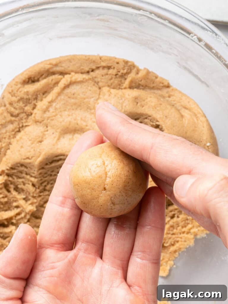 Chewy Browned Butter Snickerdoodle Cookies Recipe 7 Forming cookie dough ball with palms. Bowl with dough below.