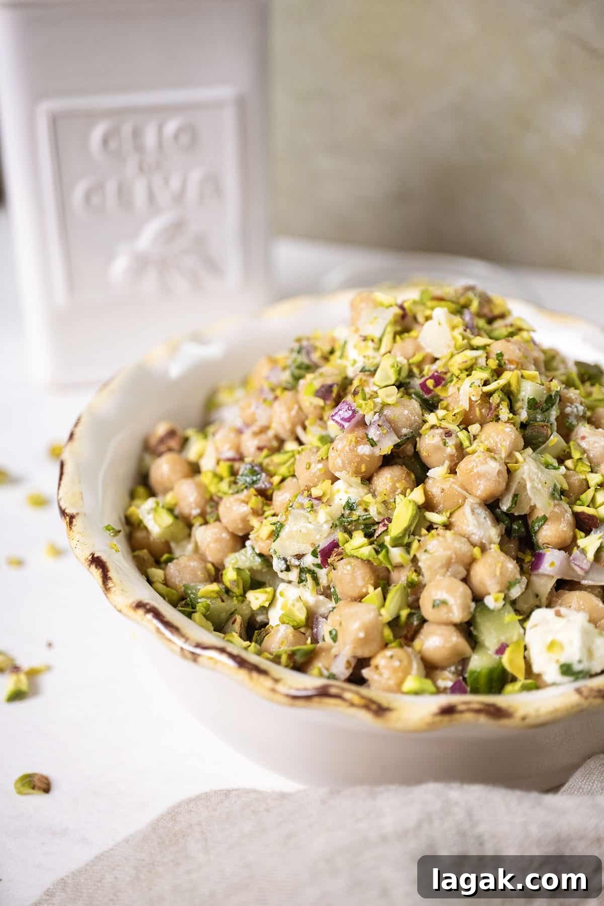 Mediterranean Chickpea, Cucumber & Feta Salad Recipe 2 Chickpea and feta salad in a bowl topped with pistachios