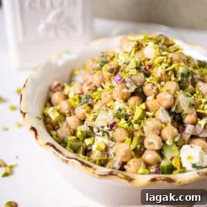Mediterranean Chickpea, Cucumber & Feta Salad Recipe 11 Chickpea and feta salad in a bowl topped with pistachios
