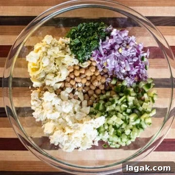 Mediterranean Chickpea, Cucumber & Feta Salad Recipe 4 Ingredients combined in a bowl.