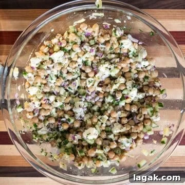 Mediterranean Chickpea, Cucumber & Feta Salad Recipe 5 Ingredients combined with dressing.