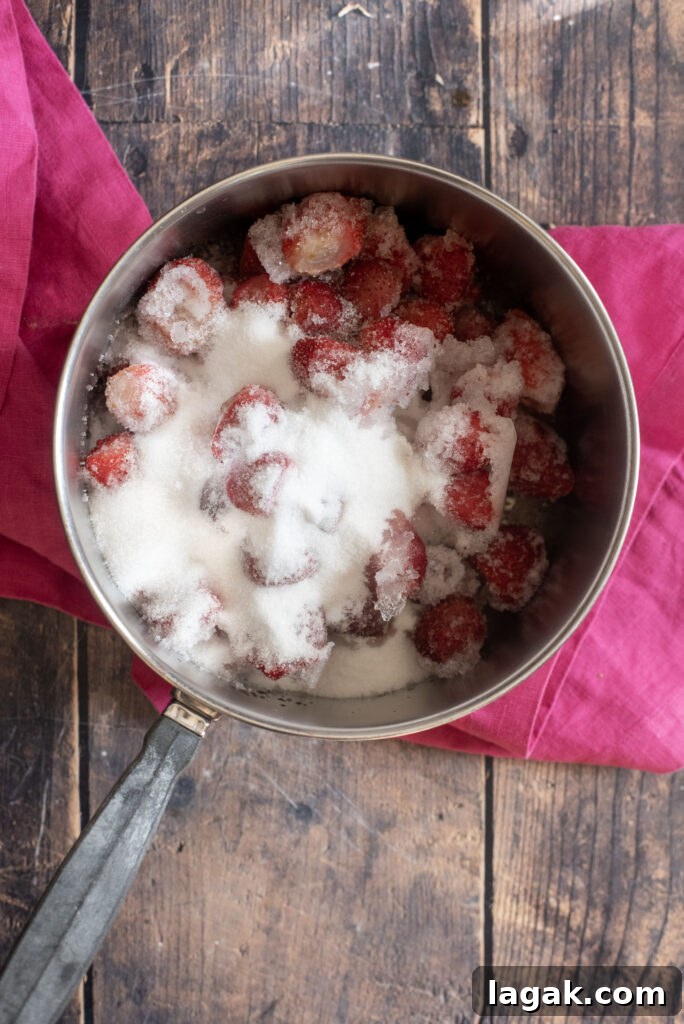Strawberry Crinkle Cookies Recipe — Soft Pink Cookies for Spring 4 Cooking strawberries in saucepan with sugar to make strawberry syrup
