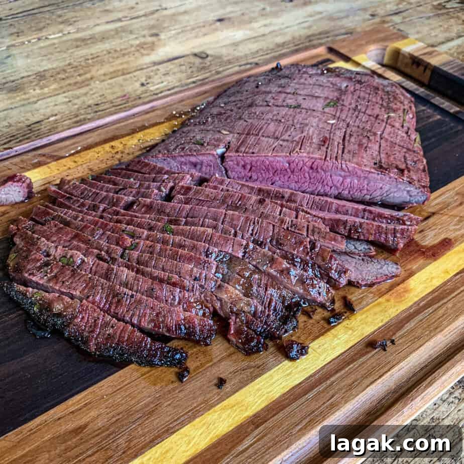 Juicy Flank Steak Tacos with Cilantro-Lime Slaw 4 Sliced flank steak on a cutting board