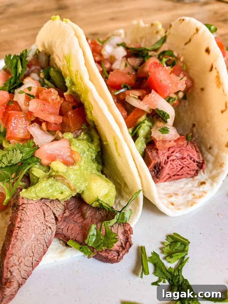 Juicy Flank Steak Tacos with Cilantro-Lime Slaw 5 flank steak tacos with pico de gallo and guacamole
