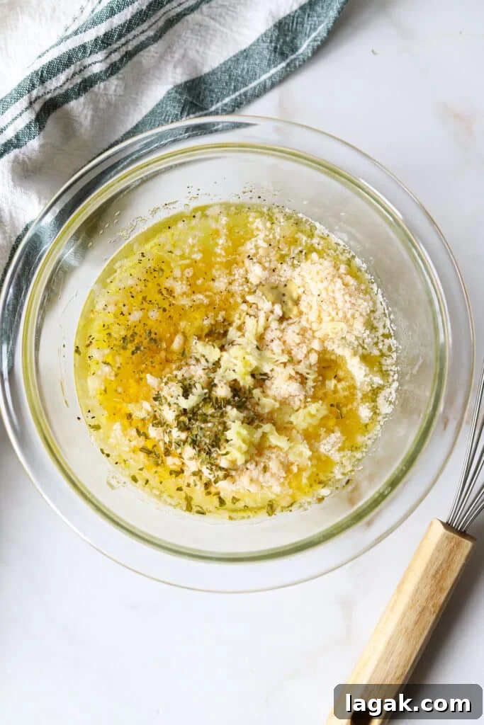 Garlic Parmesan Dressing Recipe for Salads and Veggies 4 Garlic parmesan dressing ingredients in a glass bowl, not yet mixed.
