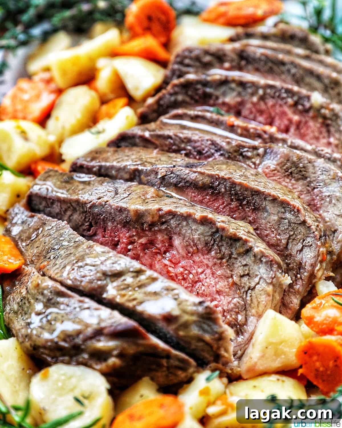 Tender Instant Pot Sirloin Tip Roast Recipe for Juicy Results 11 Sliced sirloin tip roast surrounded by carrots, potatoes, and herbs.