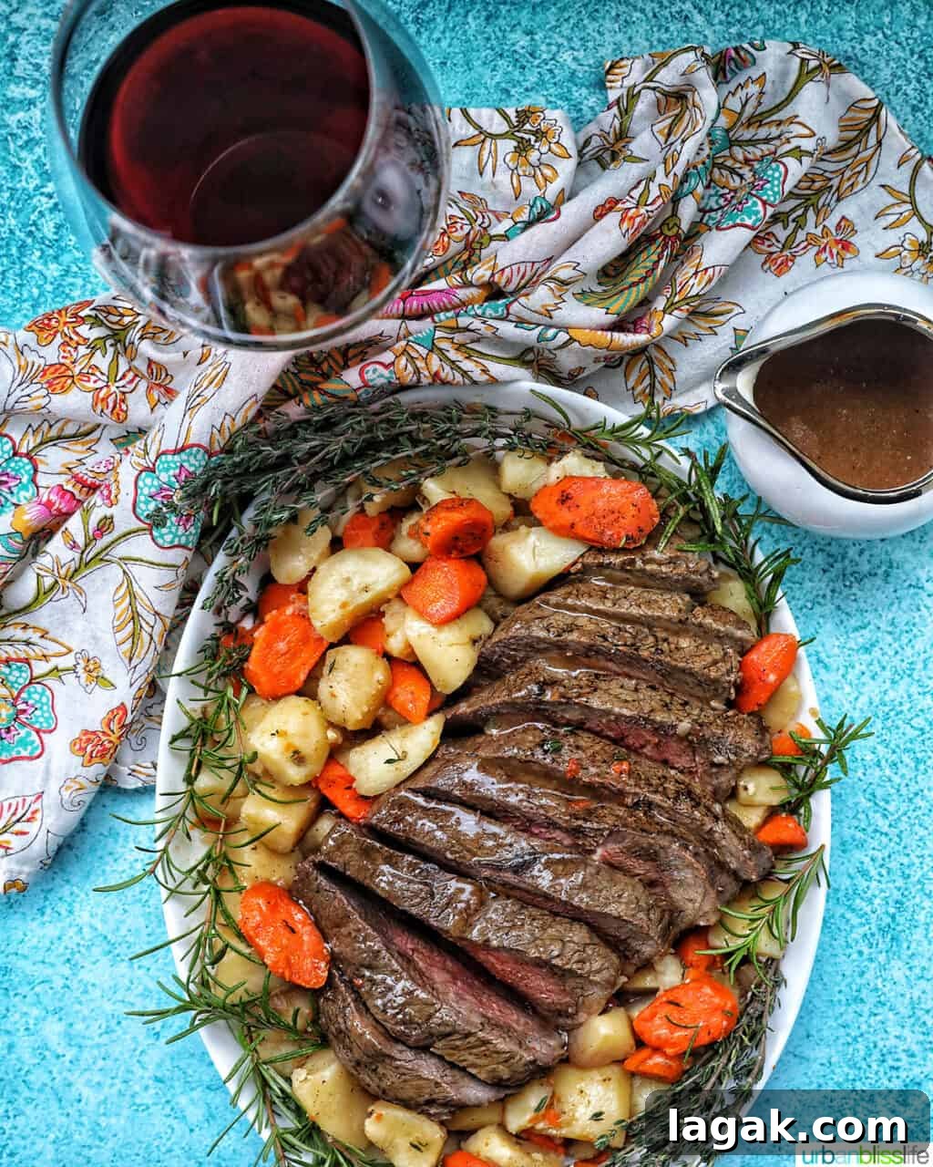 Tender Instant Pot Sirloin Tip Roast Recipe for Juicy Results 13 Sliced sirloin tip roast surrounded by carrots, potatoes, and herbs with a side of gravy and glass of red wine.