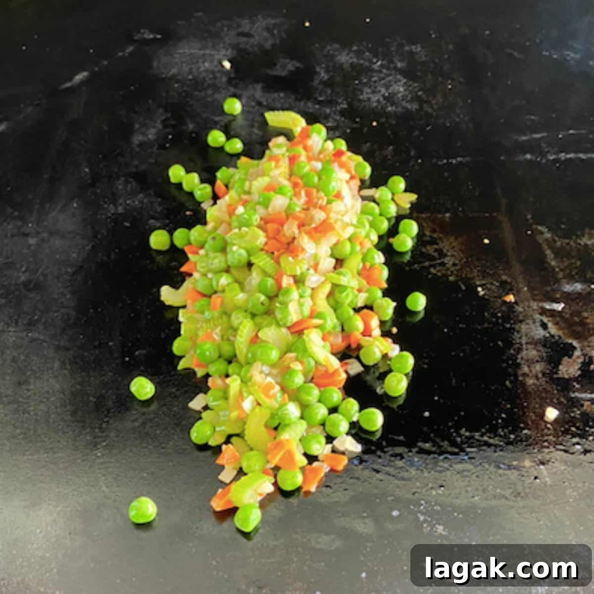 Crispy Blackstone Fried Rice Recipe for Restaurant-Style Flavor 5 Vegetables frying on blackstone.