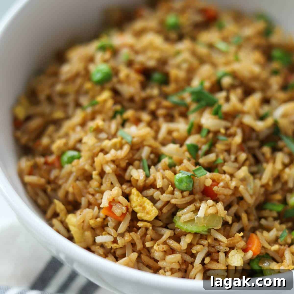 Crispy Blackstone Fried Rice Recipe for Restaurant-Style Flavor 8 Blackstone griddle fried rice in white bowl.