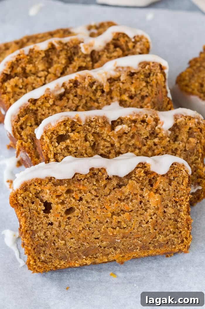 Moist Vegan Carrot Cake Loaf Recipe for Every Occasion 3 Close up of slices of vegan carrot cake loaf topped with lemon glaze.